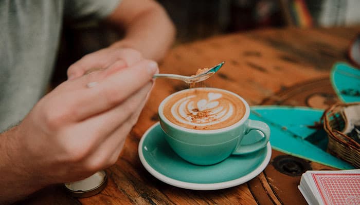 Man drinking coffee in a cafe in Headingley