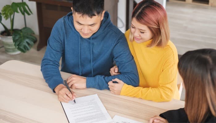 |Young couple signing document