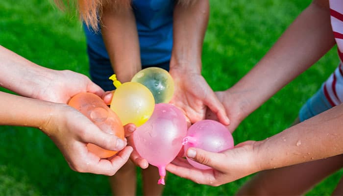 water balloons being held by children outdoors